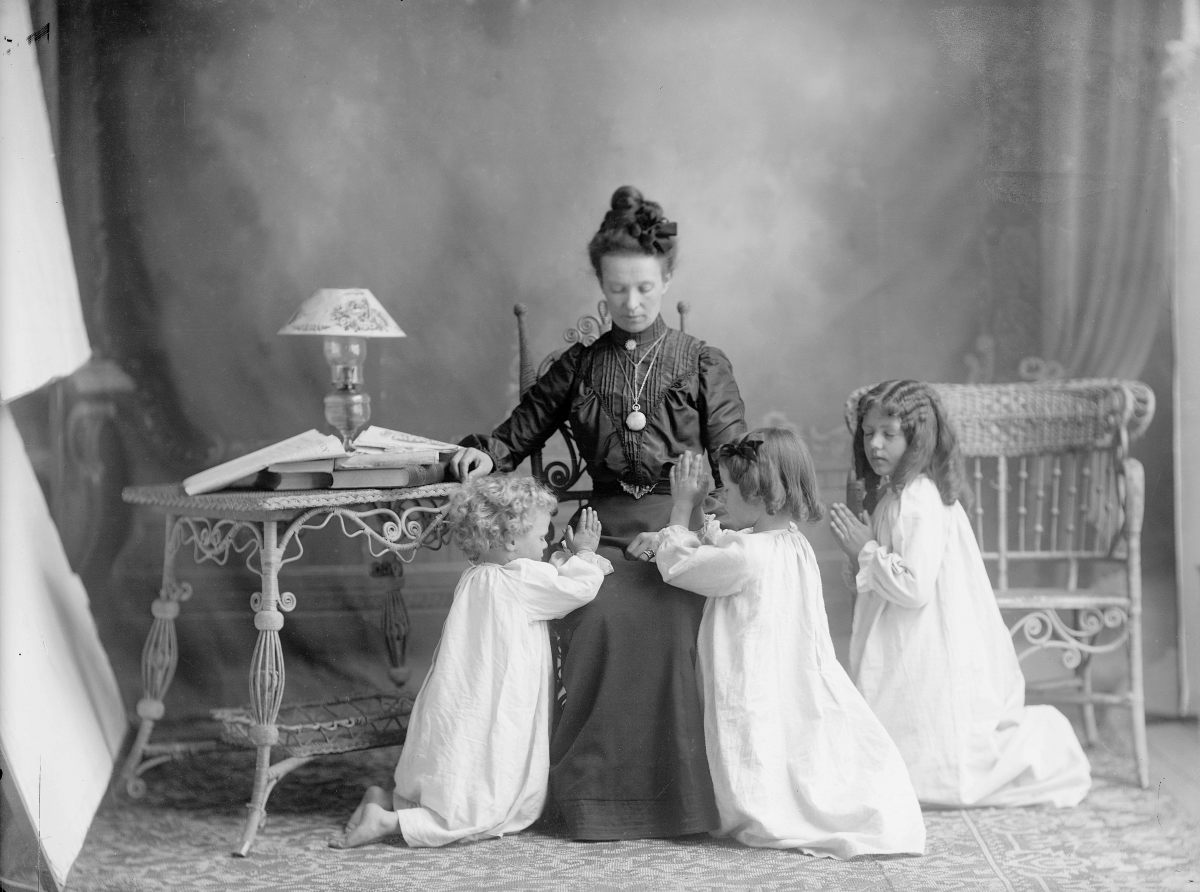 Studio photograph sent to Albert Manwaring while he served a mission in the British Isles, showing his wife, Bertha, and daughters Arvilla, Ora, and Bessie praying for him, 1903. Courtesy Daughters of Utah Pioneers and L. Tom Perry Special Collections, Harold B. Lee Library, Brigham Young University, Provo, Utah.